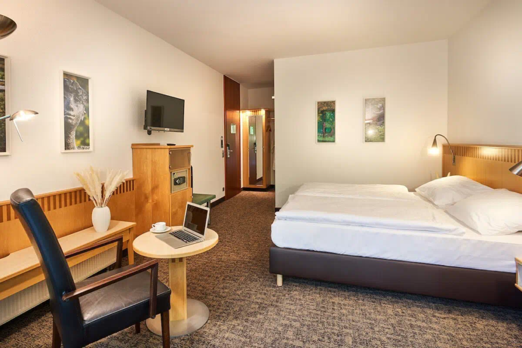 Komfortables Hotelzimmer mit Doppelbett und heller Einrichtung